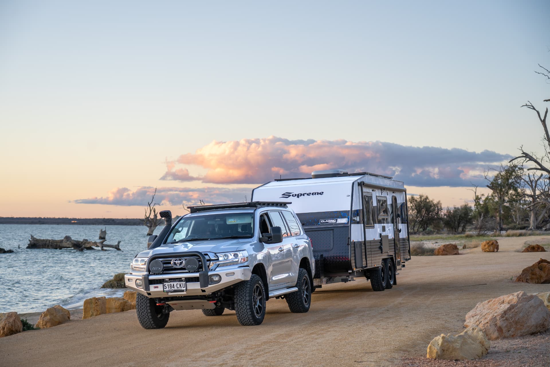 Caravan set up beside the water